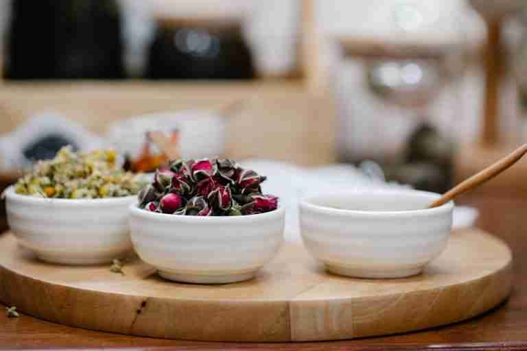 Artistic presentation of herbal ingredients in ceramic bowls, perfect for natural lifestyle and cooking themes.