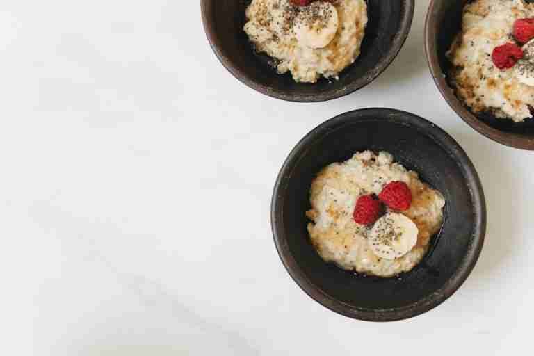 Top view of oatmeal with bananas, raspberries, and chia seeds, perfect for a healthy breakfast.