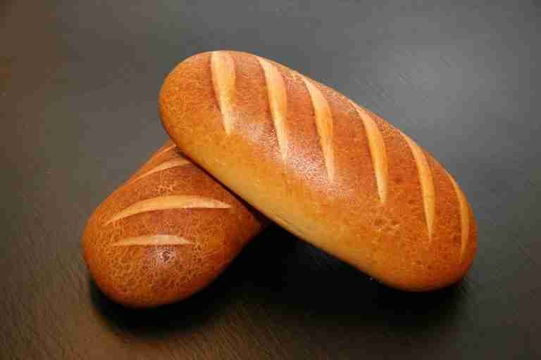 Close-up of two freshly baked loaves with crispy crust, ideal for food and still life photography.