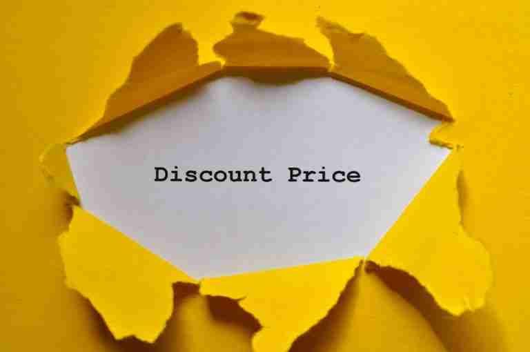 Eye-catching image of torn yellow paper revealing the words 'Discount Price.'