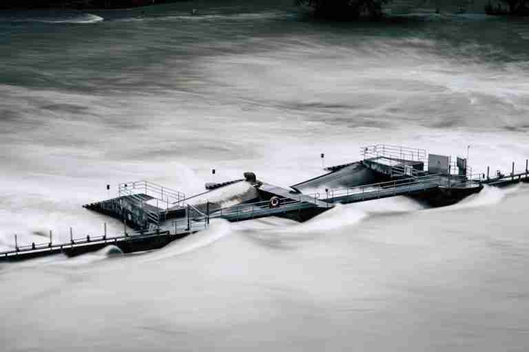 An aerial view of a structure overwhelmed by a river flood in Bern, Switzerland.