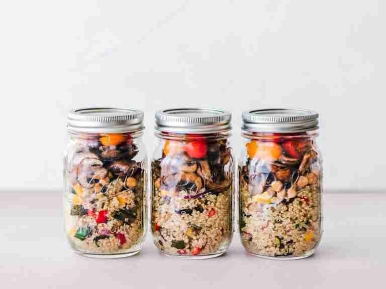 Colorful quinoa salad jar with roasted veggies, ideal for healthy meal prep.