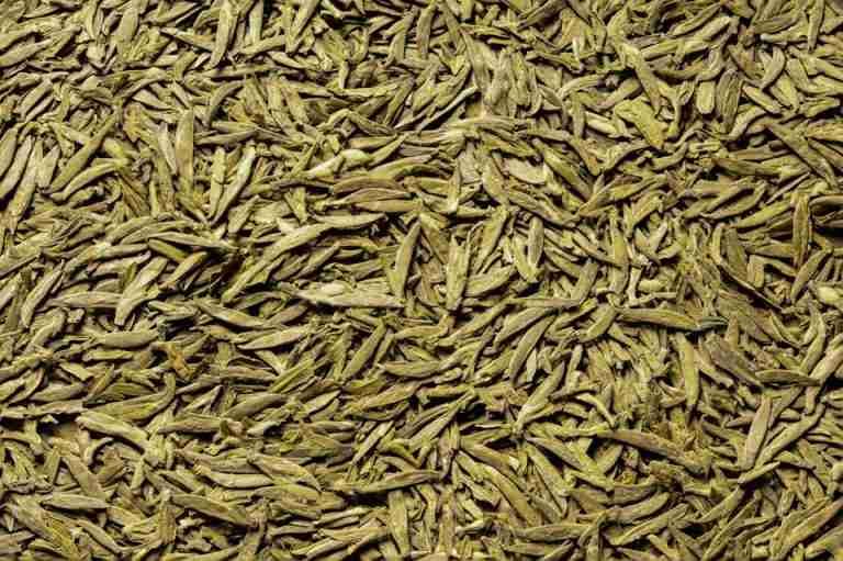 Detailed close-up of organic green tea leaves, capturing texture and color in Hangzhou.