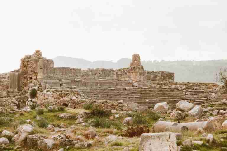 Explore the timeless beauty and historical significance of ancient stone ruins in a serene landscape.