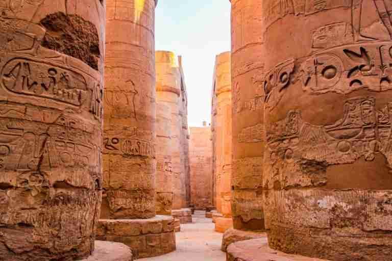 Explore the grandeur of ancient Egyptian columns adorned with hieroglyphic carvings.