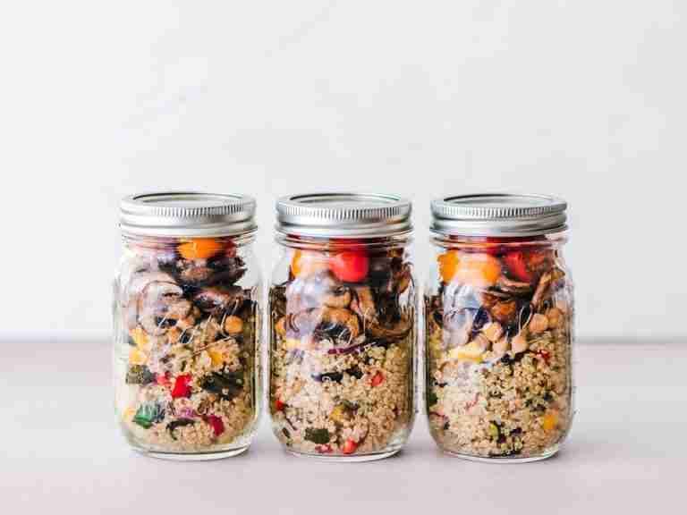 Colorful quinoa salad jar with roasted veggies, ideal for healthy meal prep.