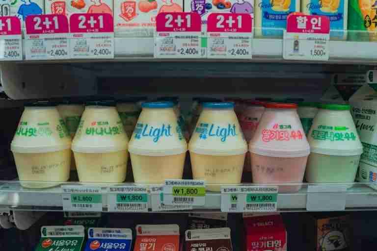 Vibrant assortment of Korean drinks in a convenience store fridge in Seoul, South Korea.
