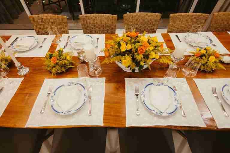 A beautifully set dining table with floral centerpieces and classic tableware for an elegant dinner.