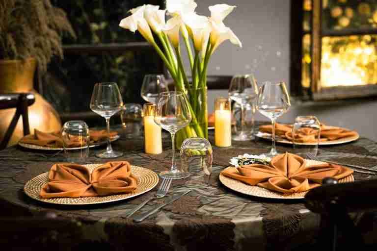 Beautifully decorated dinner table with calla lilies and warm candlelight ambiance.