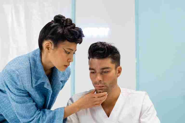A medical professional examining a patient in a clinic, focusing on health assessment.