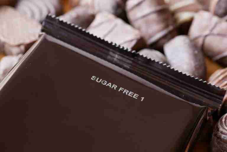 Close-up of sugar-free chocolate candies with a focus on a wrapped piece.